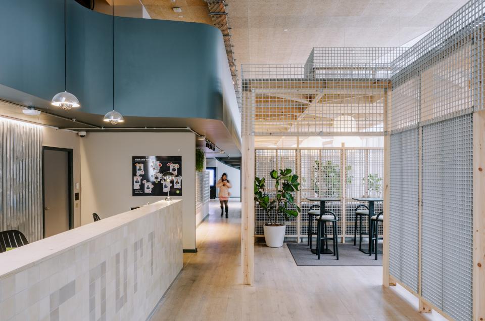 Modern interior design featuring functional workspaces and greenery, inspired by Mile End's historic streets, at iQ East Court.