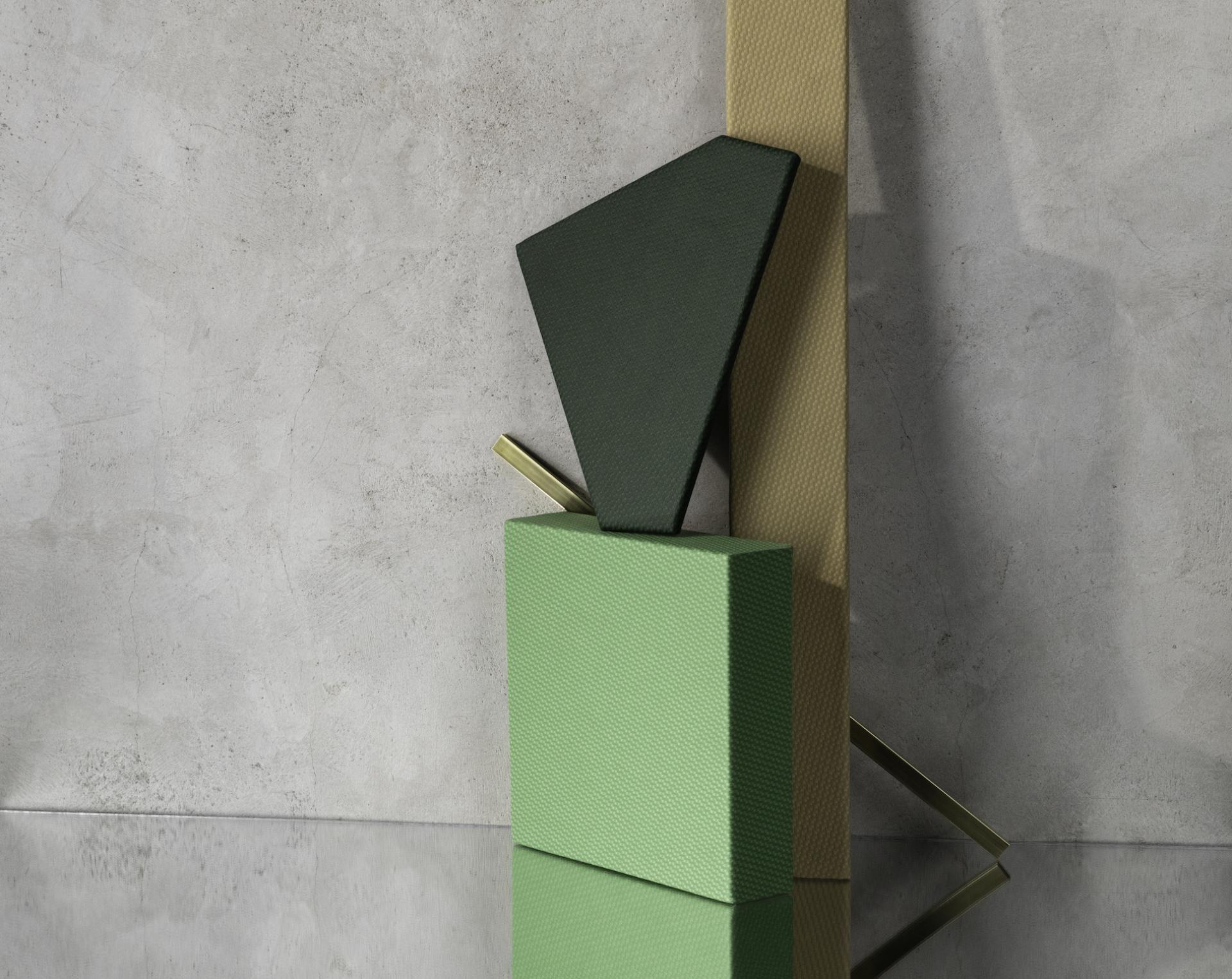 Textured green and black geometric shapes displayed against a minimalist background, showcasing Bauhaus-inspired design in performance textiles.