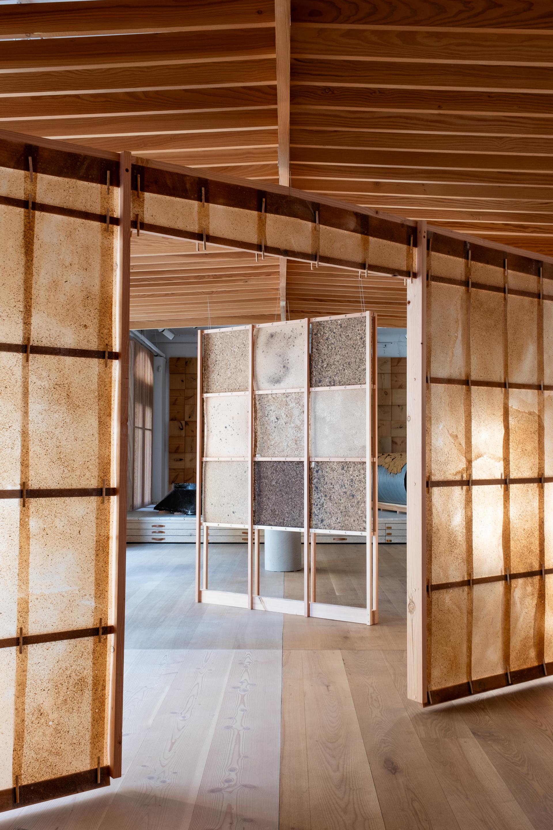 Interior view showcasing SMULD's innovative wooden material installations featuring textured panels and sustainable architectural design elements.