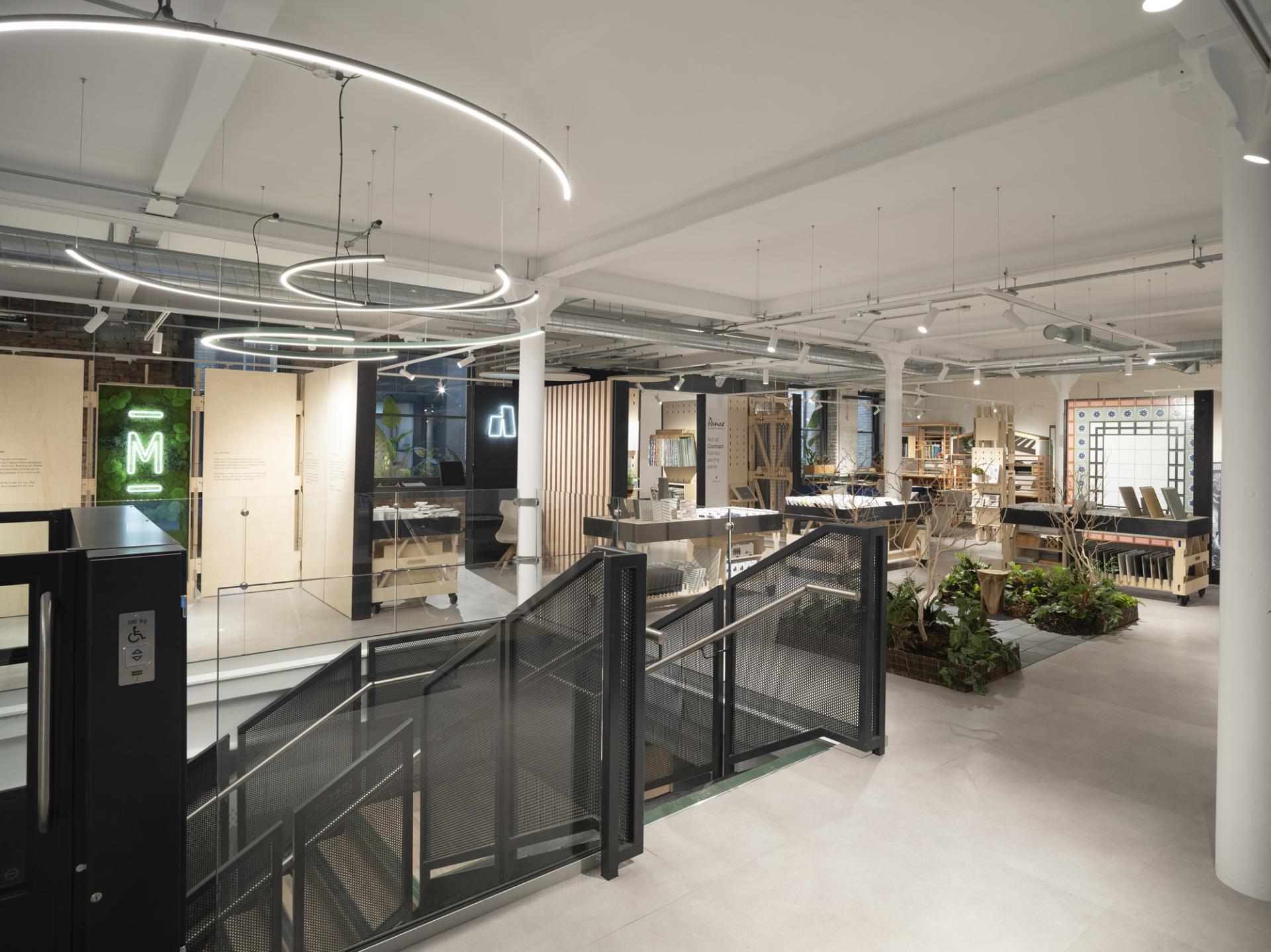 Modern interior of Material Source Studio in Manchester's NOMA, featuring sleek design, natural elements, and creative display areas.