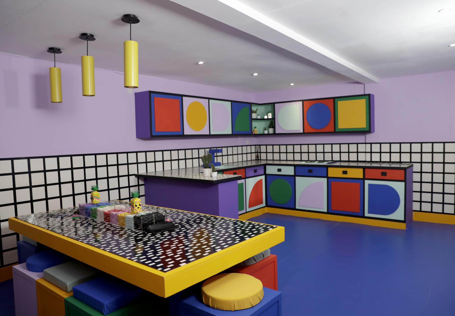 Colorful kitchen interior with geometric patterns, designed by Camille Walala for the LEGO House of Dots installation.