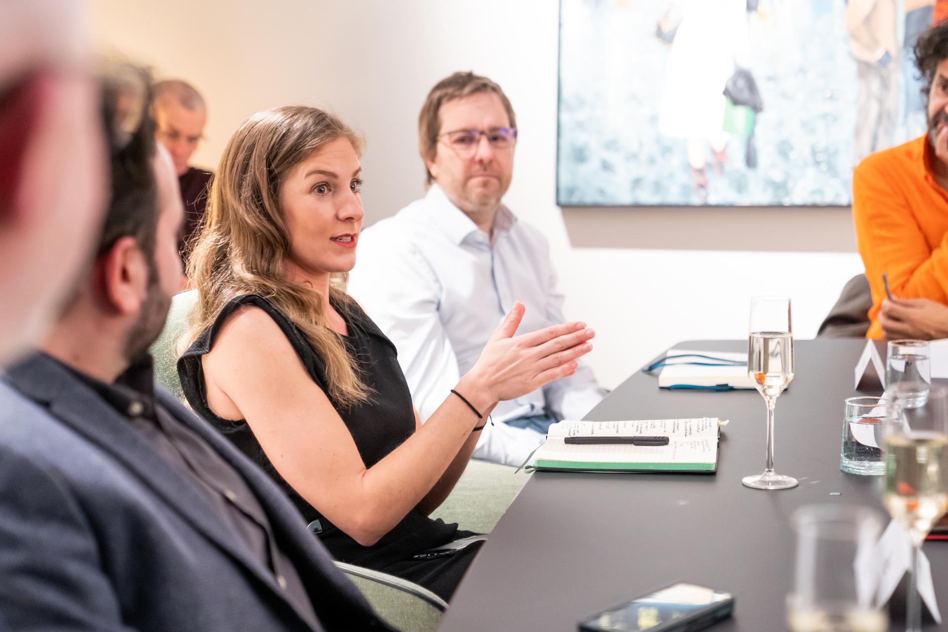 Participants engage in a discussion about sustainability at a seminar, highlighting collaboration and accountability in environmental initiatives.