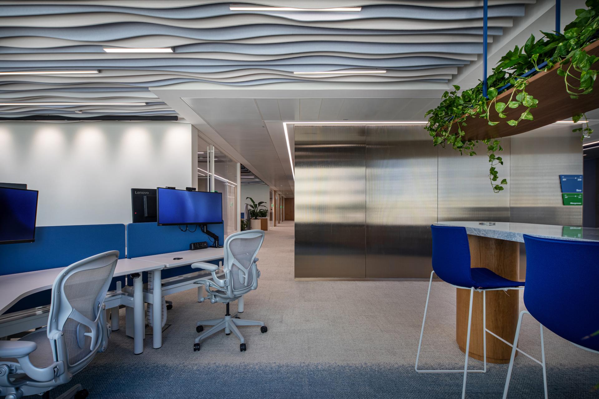 Brightly designed modern office space in Dubai featuring ergonomic furniture, vibrant colors, and nature-inspired decor elements.