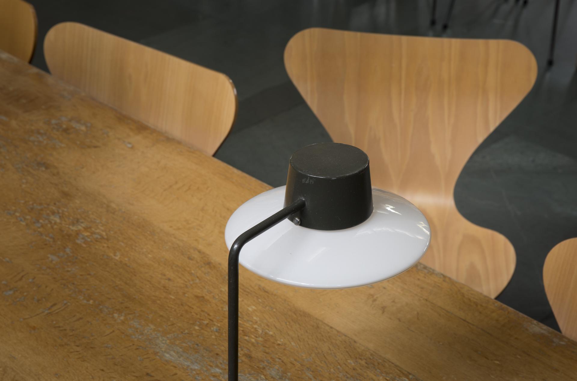 Stylish black and white lamp on a wooden table, surrounded by Scandinavian design chairs at St Catherine's College, Oxford.