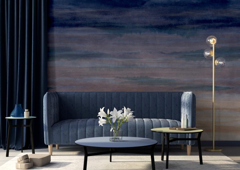 Elegant living room featuring Muraspec's Dreamscape ombre wallcovering, blue velvet sofa, and stylish decor accents.