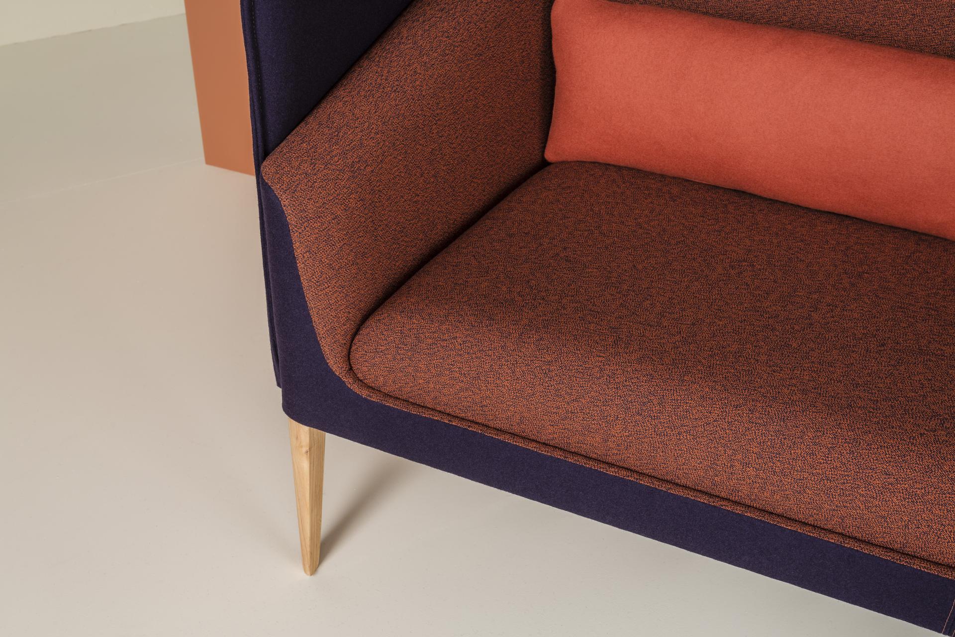 Stylish Kyoto collection sofa featuring vibrant orange and purple upholstery with elegant wooden legs, showcasing modern comfort and design.