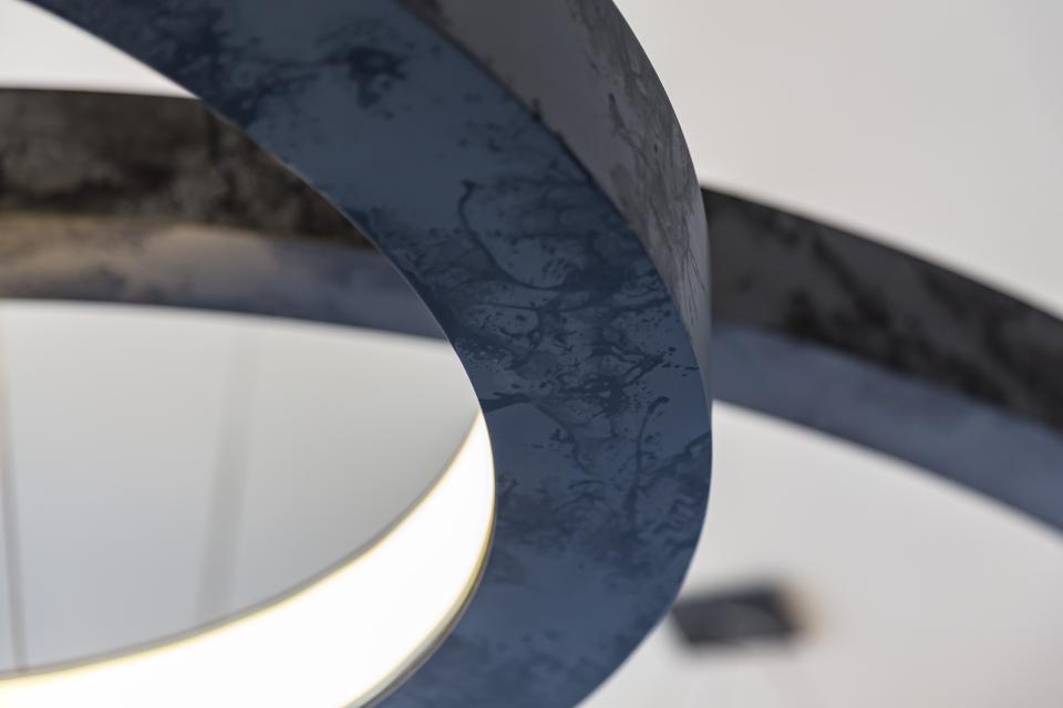 Modern pendant lighting with a sleek dark finish showcased in Elliot James’ award-winning apartment design.