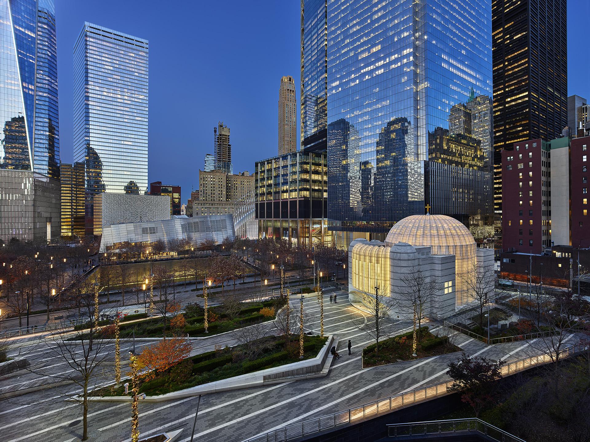 Modern architectural landscape featuring a unique domed structure amid skyscrapers in an urban setting at dusk.