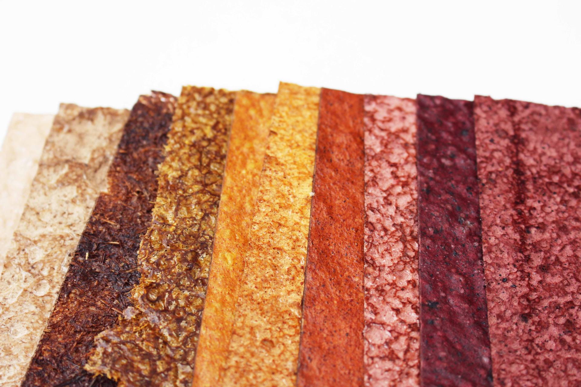 Colorful strips of BioMarble material showcase its unique textures and natural beauty as it degrades.