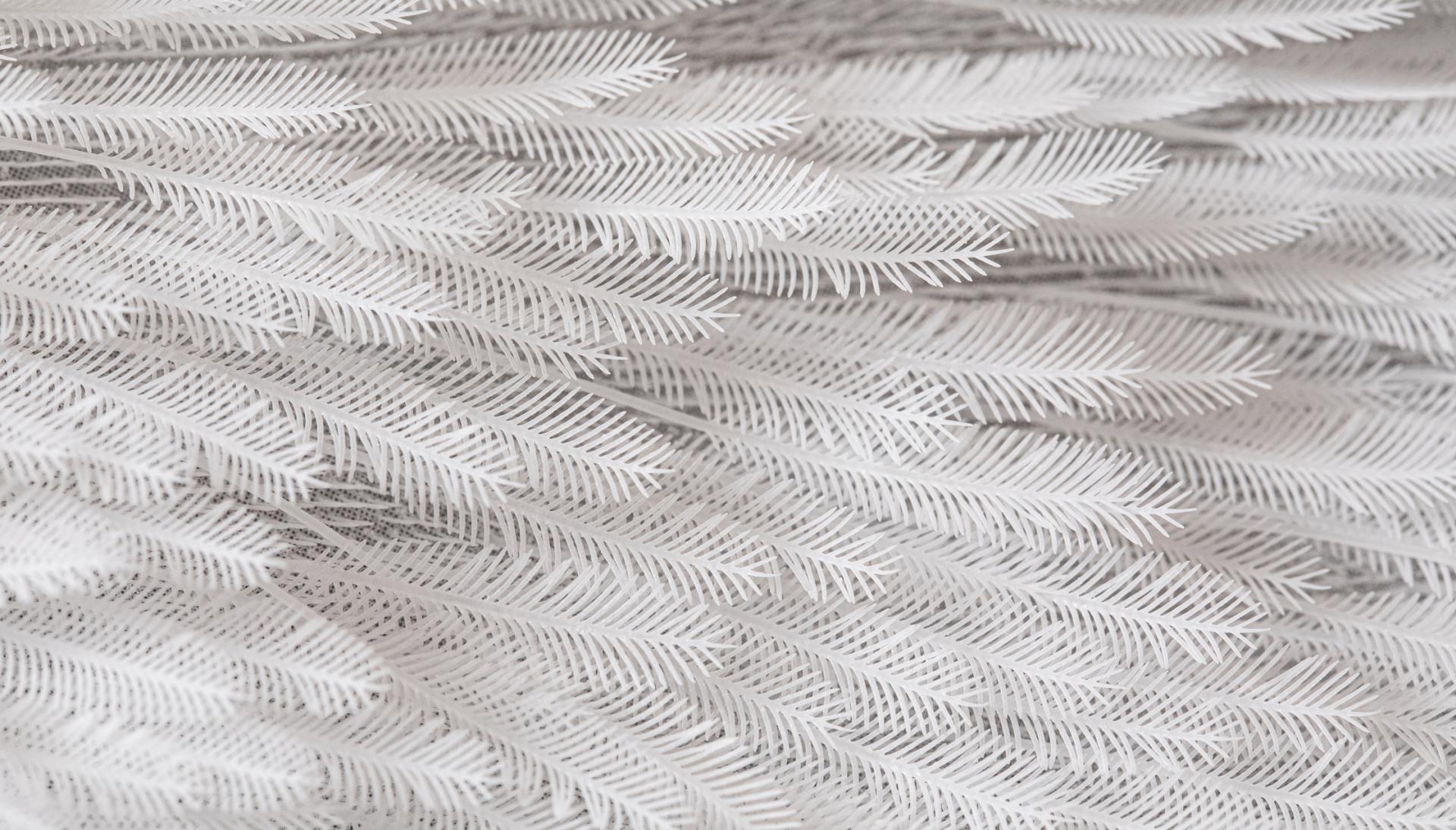 Textured white material resembling delicate foliage, showcasing innovative design and sustainable materials in modern applications.