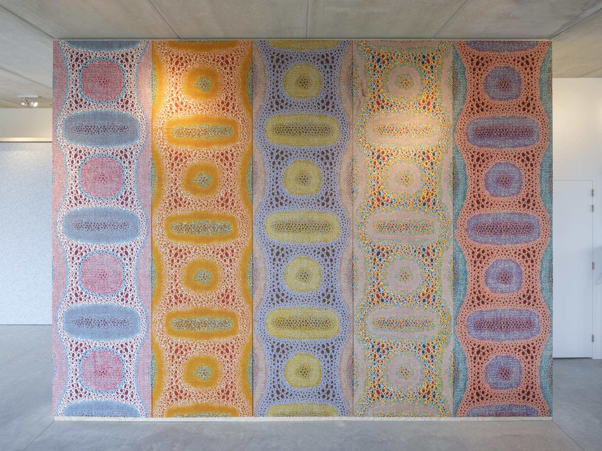 Colorful abstract wall mural featuring circular patterns, enhancing thonik's newly designed studio in Amsterdam.