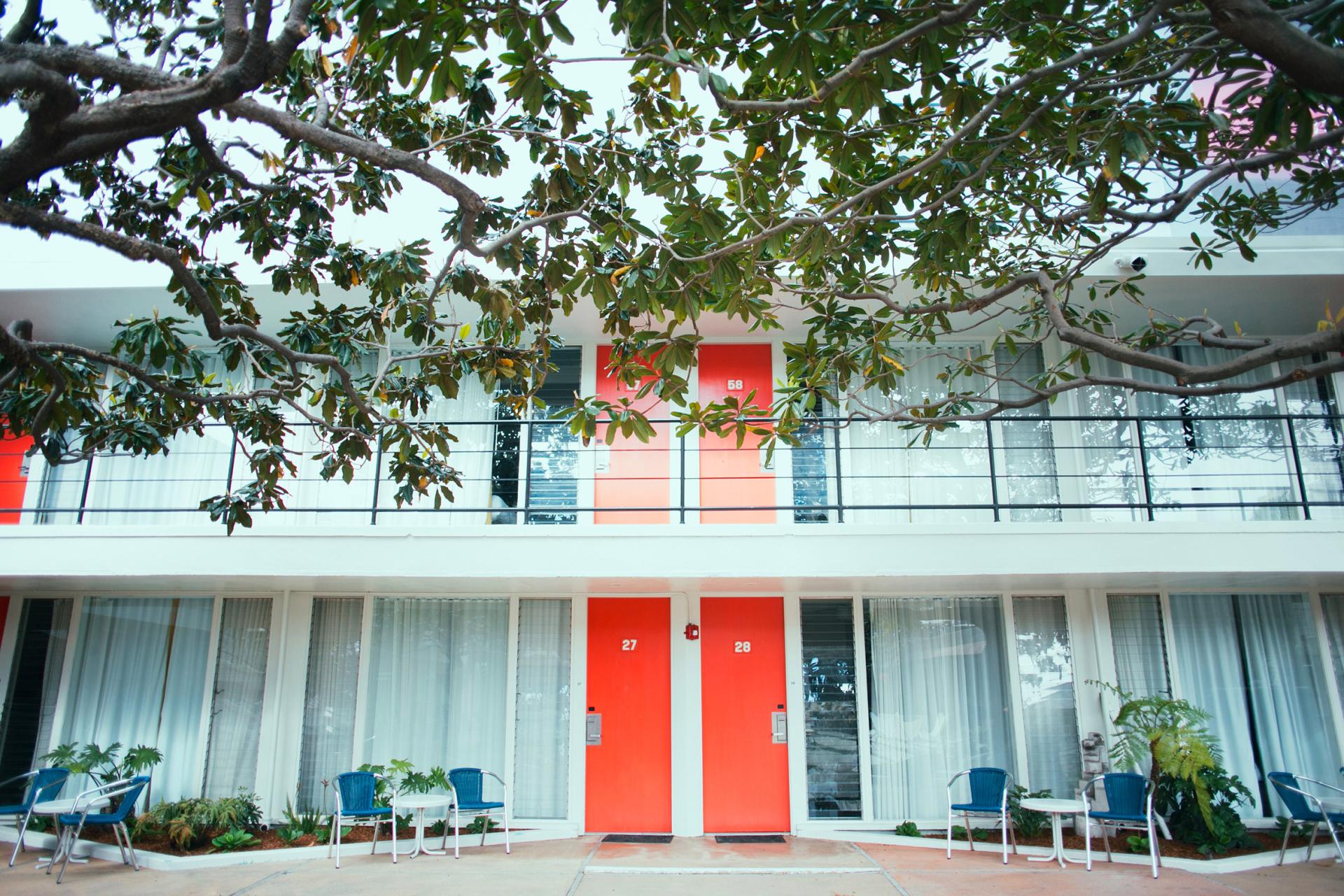 Stylish exterior of the Phoenix Hotel featuring vibrant red doors and modern design in San Francisco's Tenderloin district.