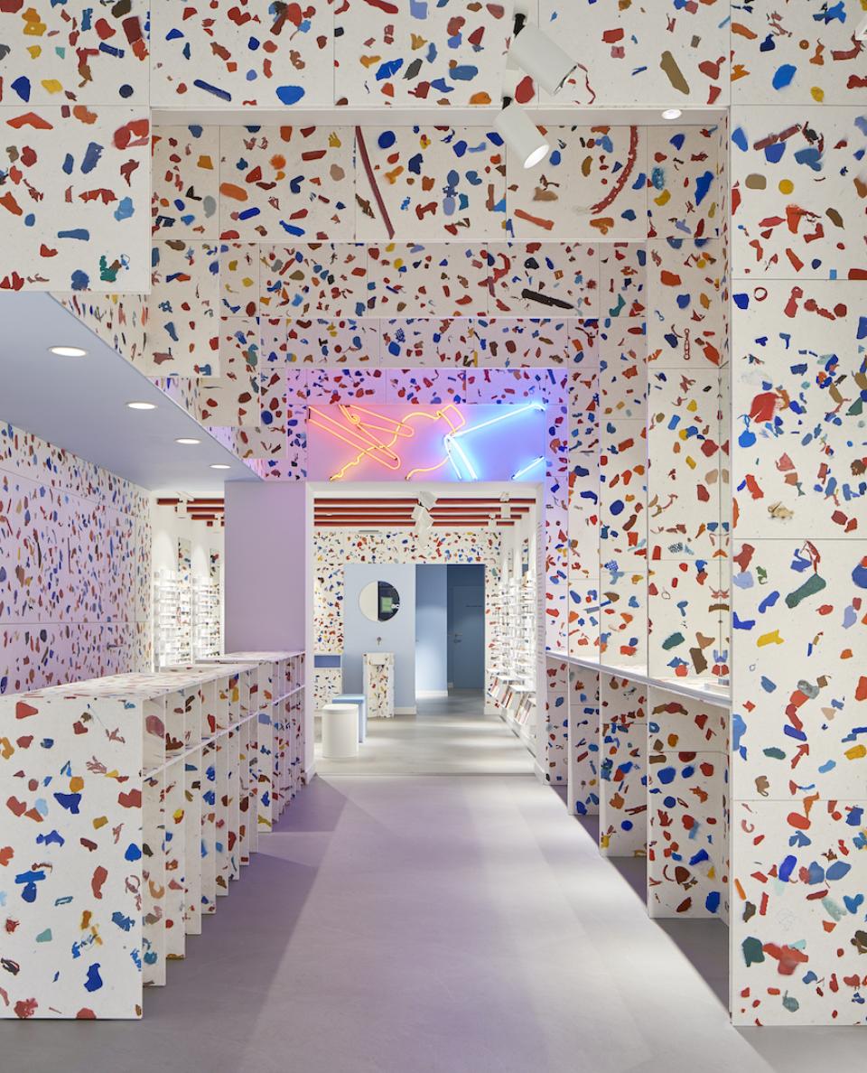 A brightly colored interior of an Amsterdam eyewear store featuring fully recycled materials and modern design elements.