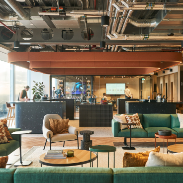Modern workspace design featuring stylish seating, collaborative areas, and panoramic city views for Bentley Systems.