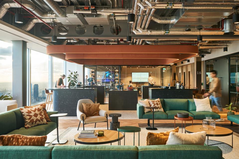 Modern workspace design featuring stylish seating, collaborative areas, and panoramic city views for Bentley Systems.