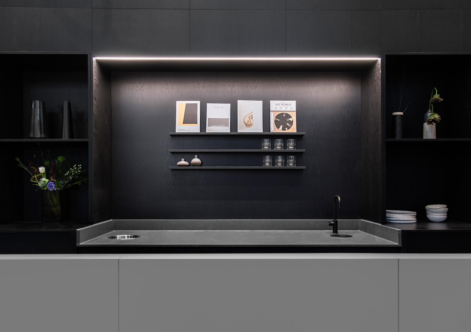 Modern kitchen design featuring minimalist cabinetry, stylish decor, and curated display items, embodying Youth Studio's aesthetic.