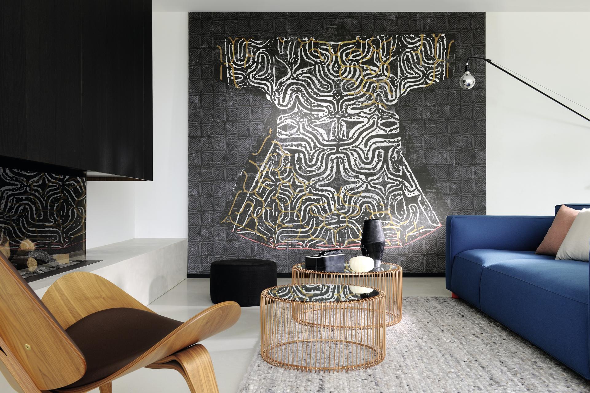 Stylish living room featuring a striking wall art piece resembling a traditional garment, highlighting modern design elements.