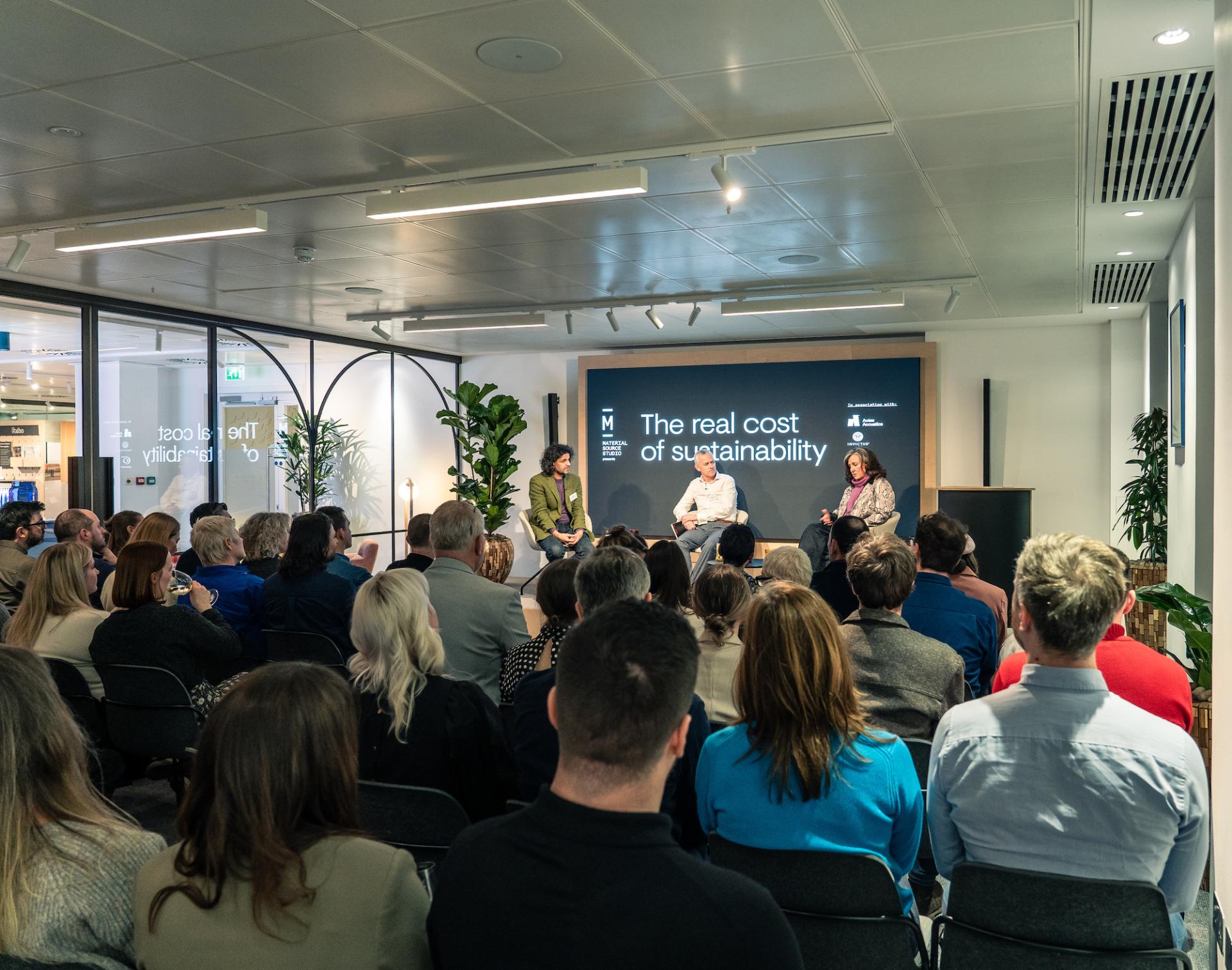 Panel discussion on the real cost of sustainability at Material Source Studio in Glasgow, engaging an audience on environmental issues.