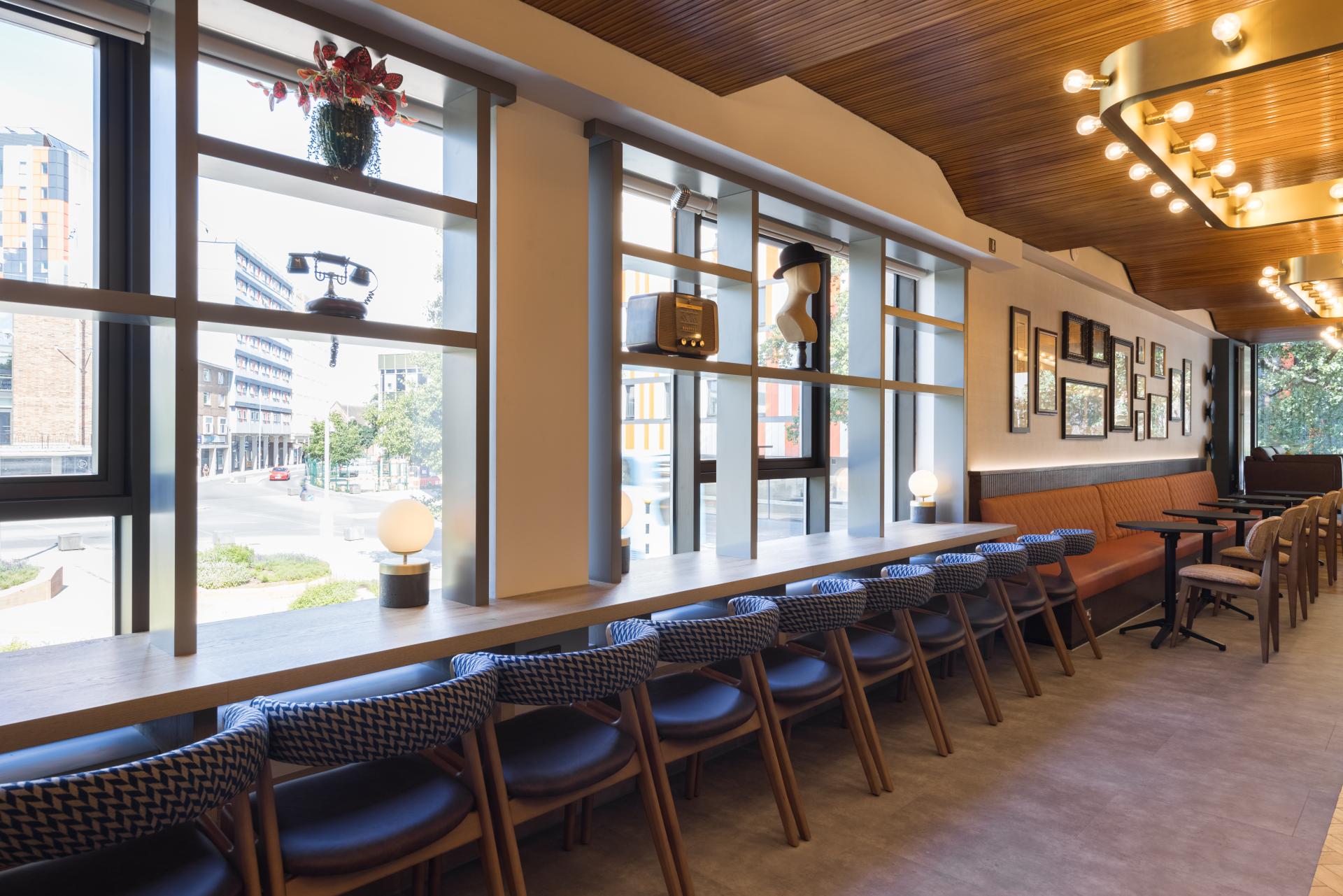 Modern interior design of the Belgrade Theatre's café, showcasing vintage decor and a spacious seating area.