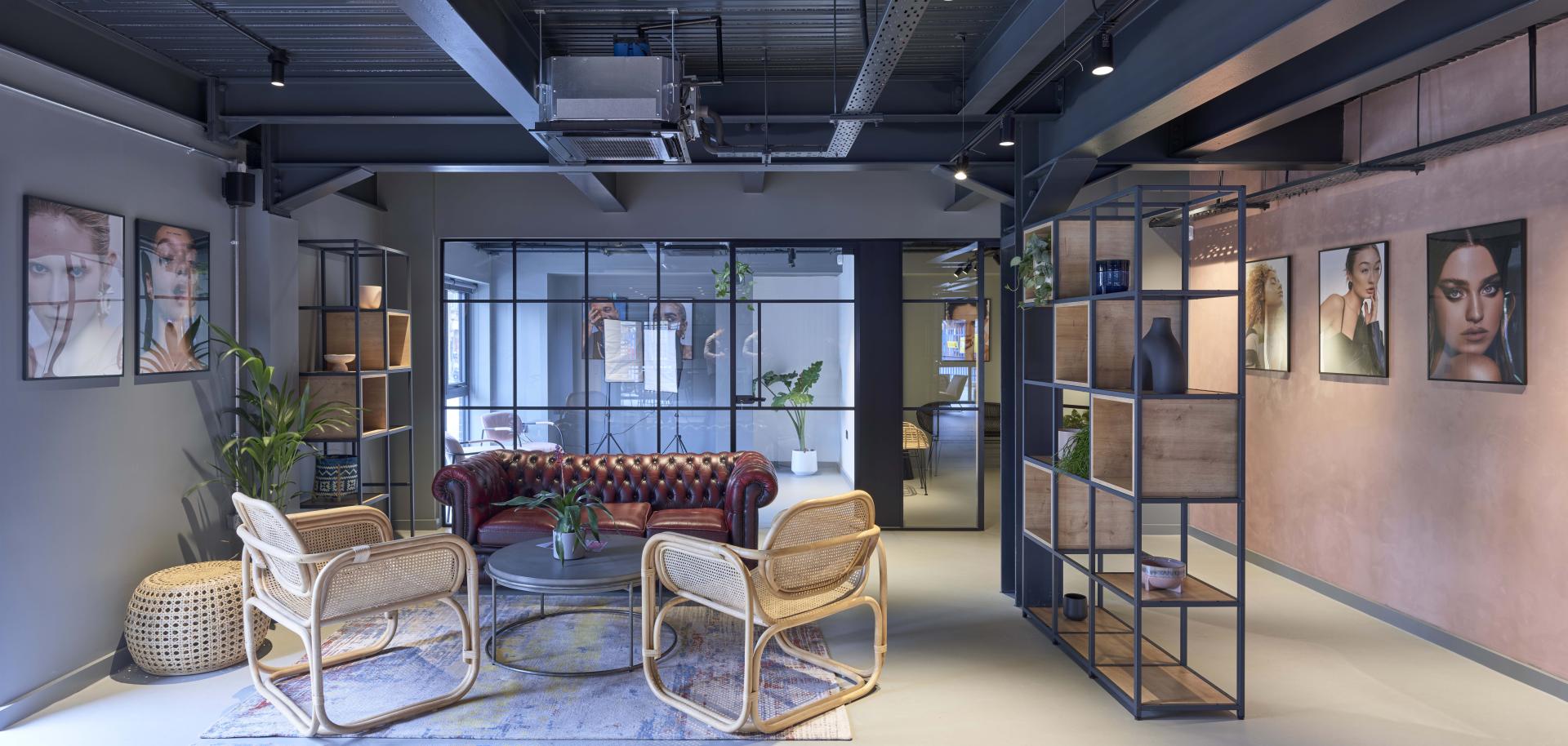 Stylish interior of J’adore Models' new headquarters featuring modern lounge seating and decorative artwork.