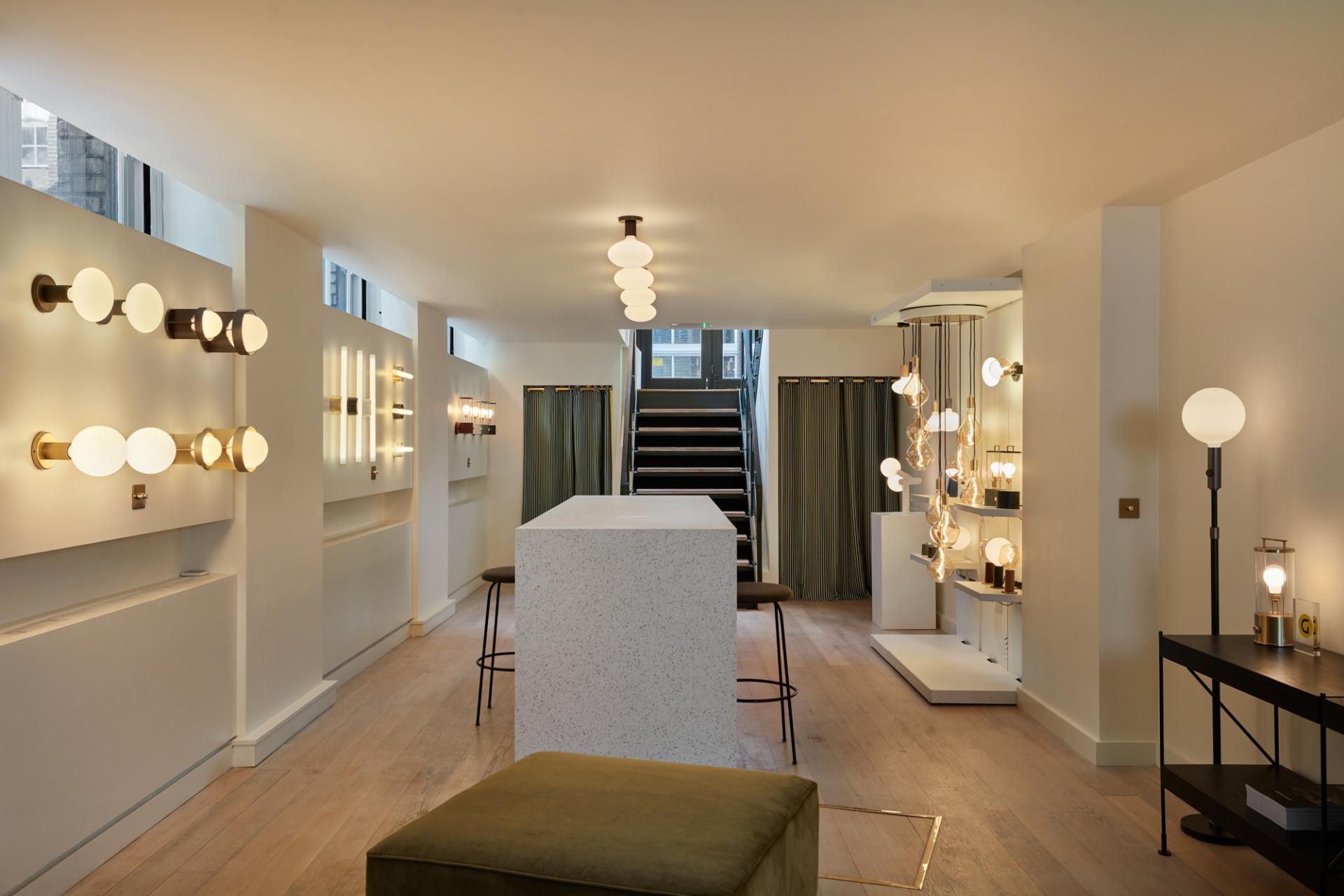 Showroom interior featuring elegant light fixtures, designed by Tala and Thomas Longley, in a modern, stylish setting.
