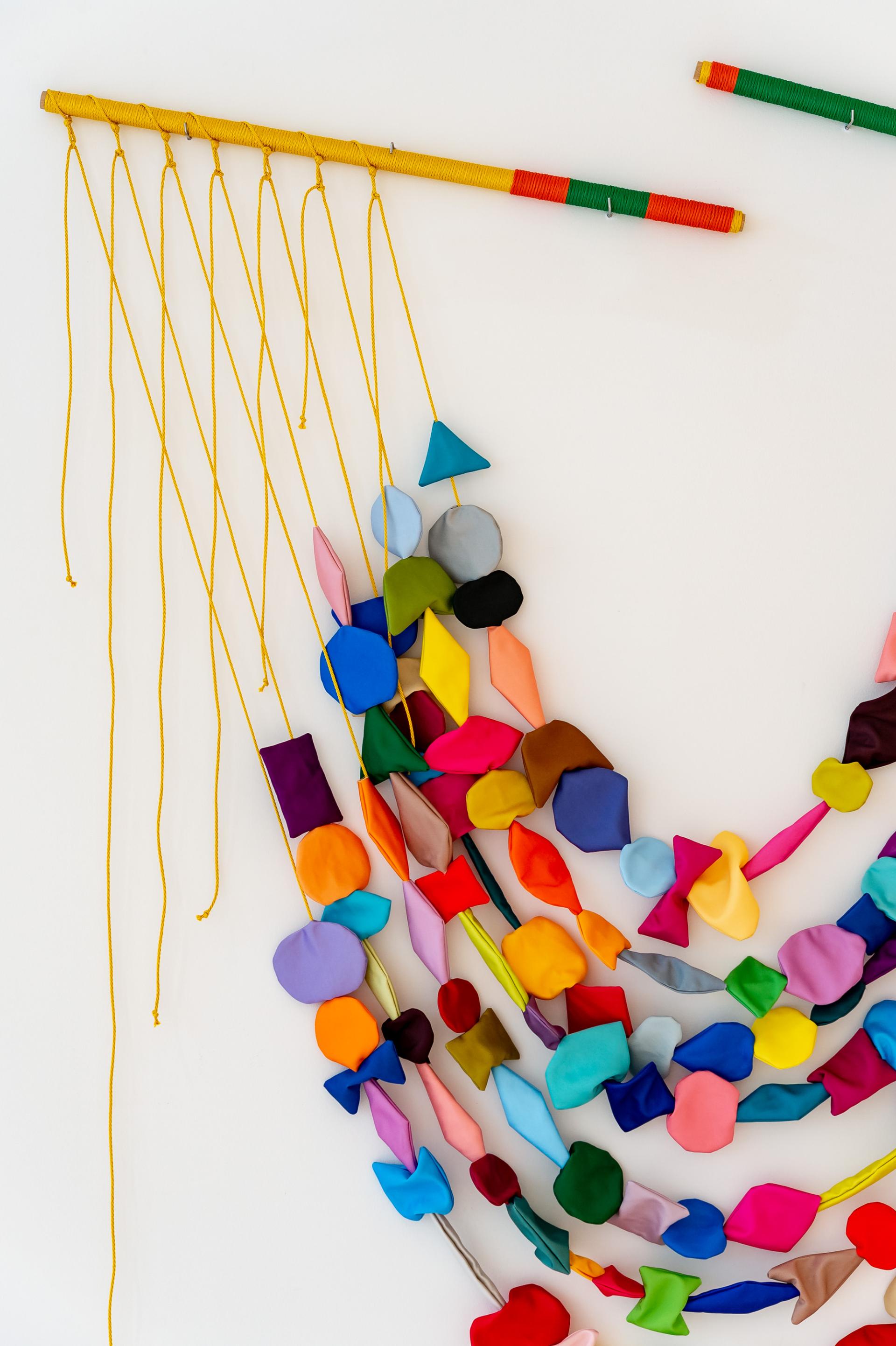 Textile artwork by Anna Ray, featuring colorful fabric shapes and woven elements, celebrating London's historic weaving trade.