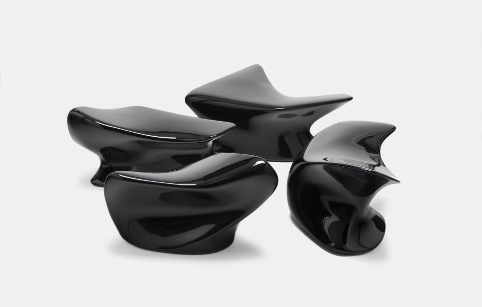 Sleek black contemporary seating pieces showcasing modern design by Established & Sons, highlighting innovative craftsmanship and style.