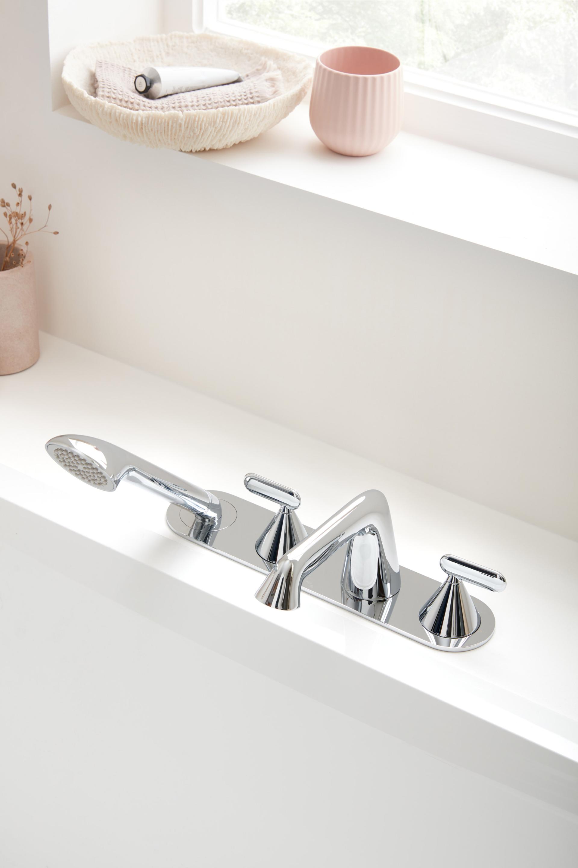 VADO's sleek Arrondi faucet design with modern chrome finish, showcased in a bright, contemporary bathroom setting.