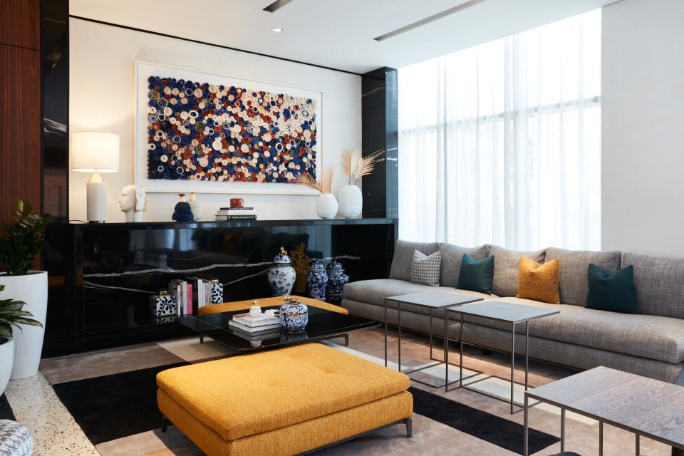 Modern hotel lounge at The8 in Dubai featuring vibrant art, contemporary furniture, and elegant decor elements.