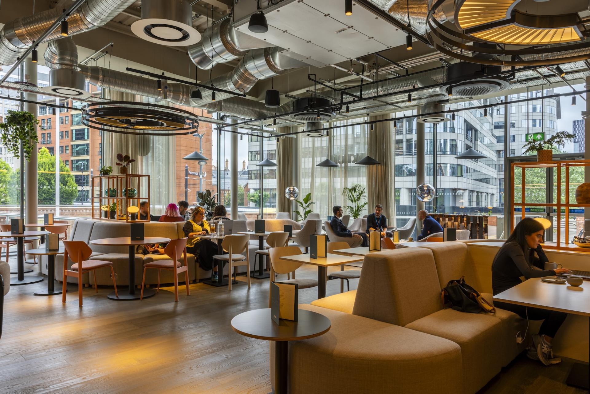 Stylish café interior at Junction Manchester Central, featuring modern seating, natural light, and collaborative spaces for professionals.