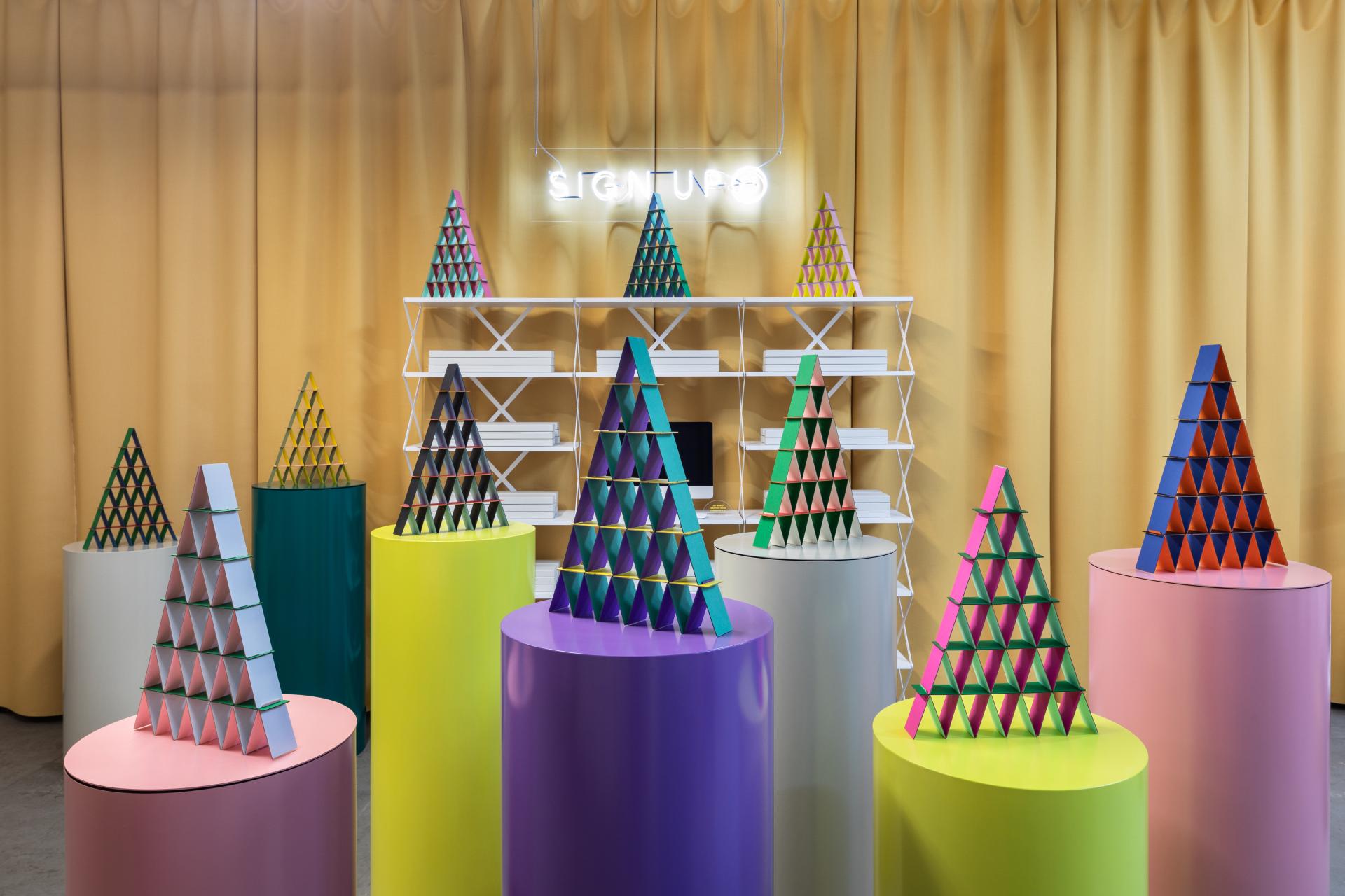 Colorful, geometric displays of stacked pyramids in a modern design exhibition setting at LDF19 by Hem.