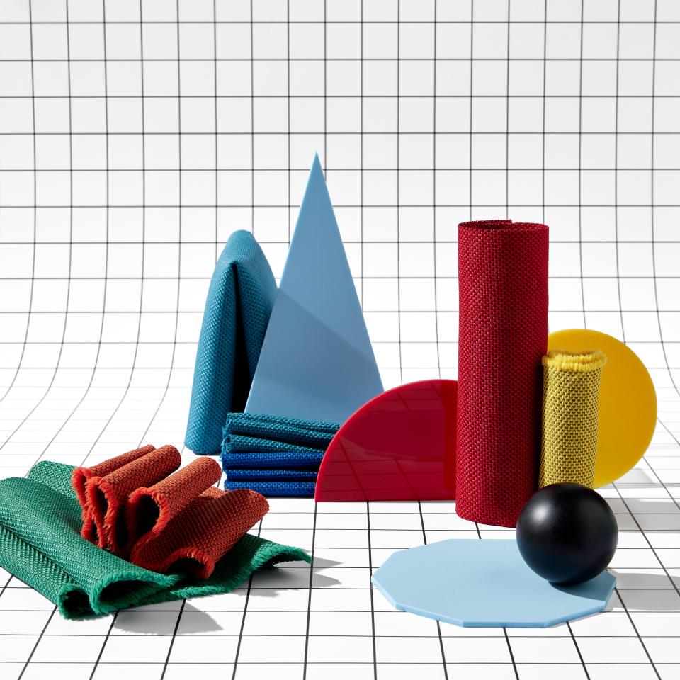 Brightly colored geometric shapes and textiles showcasing Camira's eco-friendly RePlay range of contract fabrics.