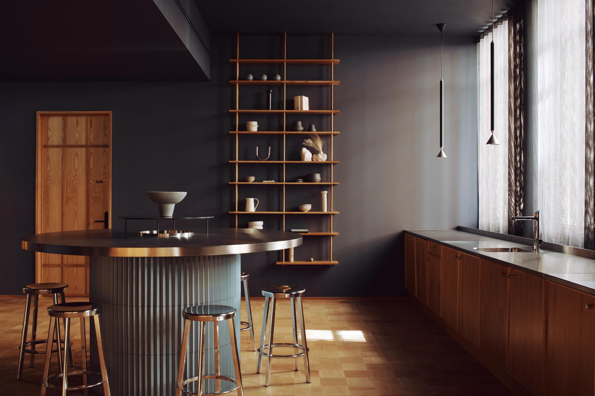 Modern kitchen space in Summit House, featuring a sleek round bar, wooden accents, and minimalist decor for The Office Group.