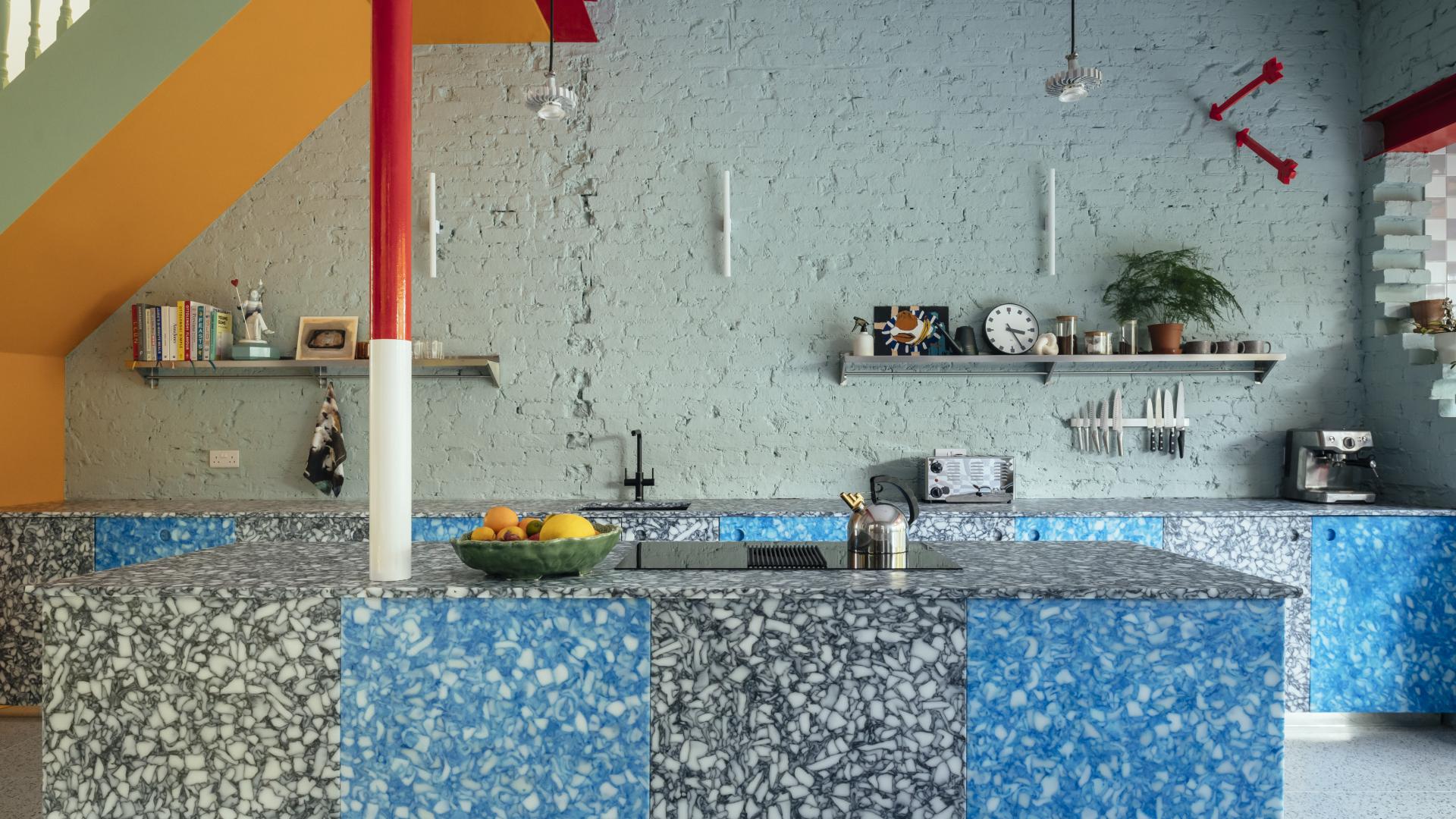 Bright and colorful kitchen featuring a unique marble countertop and vibrant wall paint in an Edwardian home transformation.