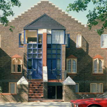 Modern British architecture featuring a unique brick facade, distinctive blue doors, and geometric design elements.