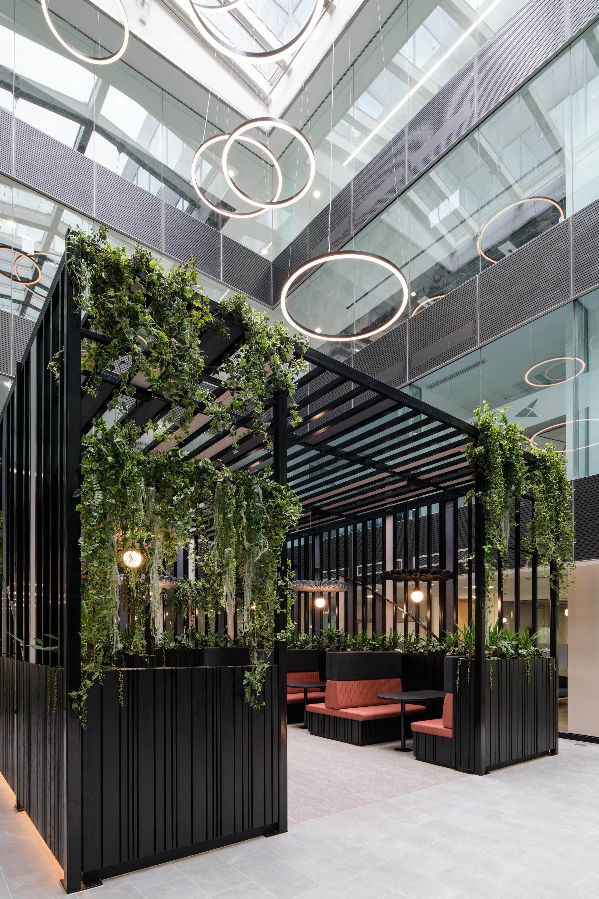 Interior transformation of One Piccadilly Gardens with lush greenery, modern seating, and contemporary lighting by SpaceInvader.