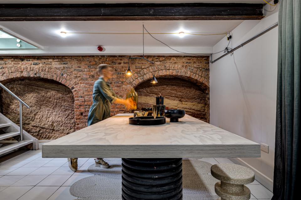 Interior design showcase by MONIKA Studio, featuring a modern table and unique decor in a stylish living space.