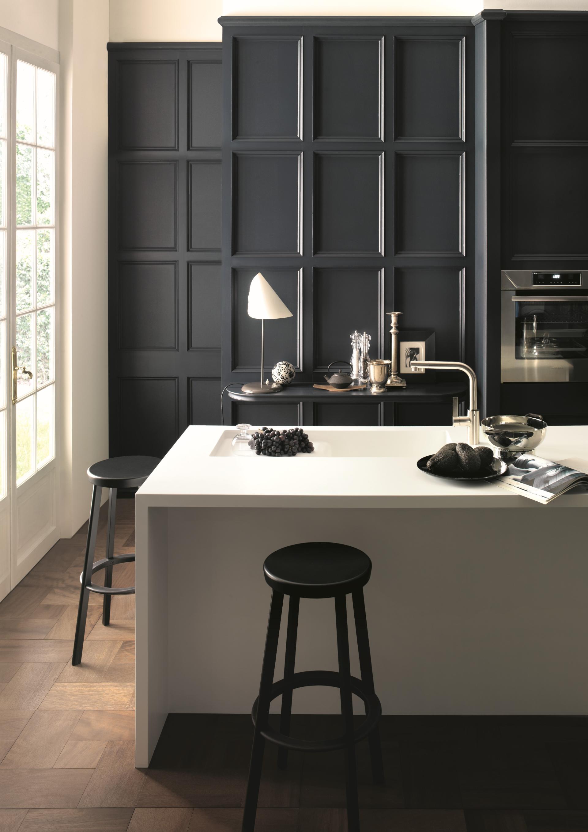 Modern kitchen featuring sleek surfaces, minimalist design, dark cabinetry, and stylish accessories, highlighting CDUK's latest trends.