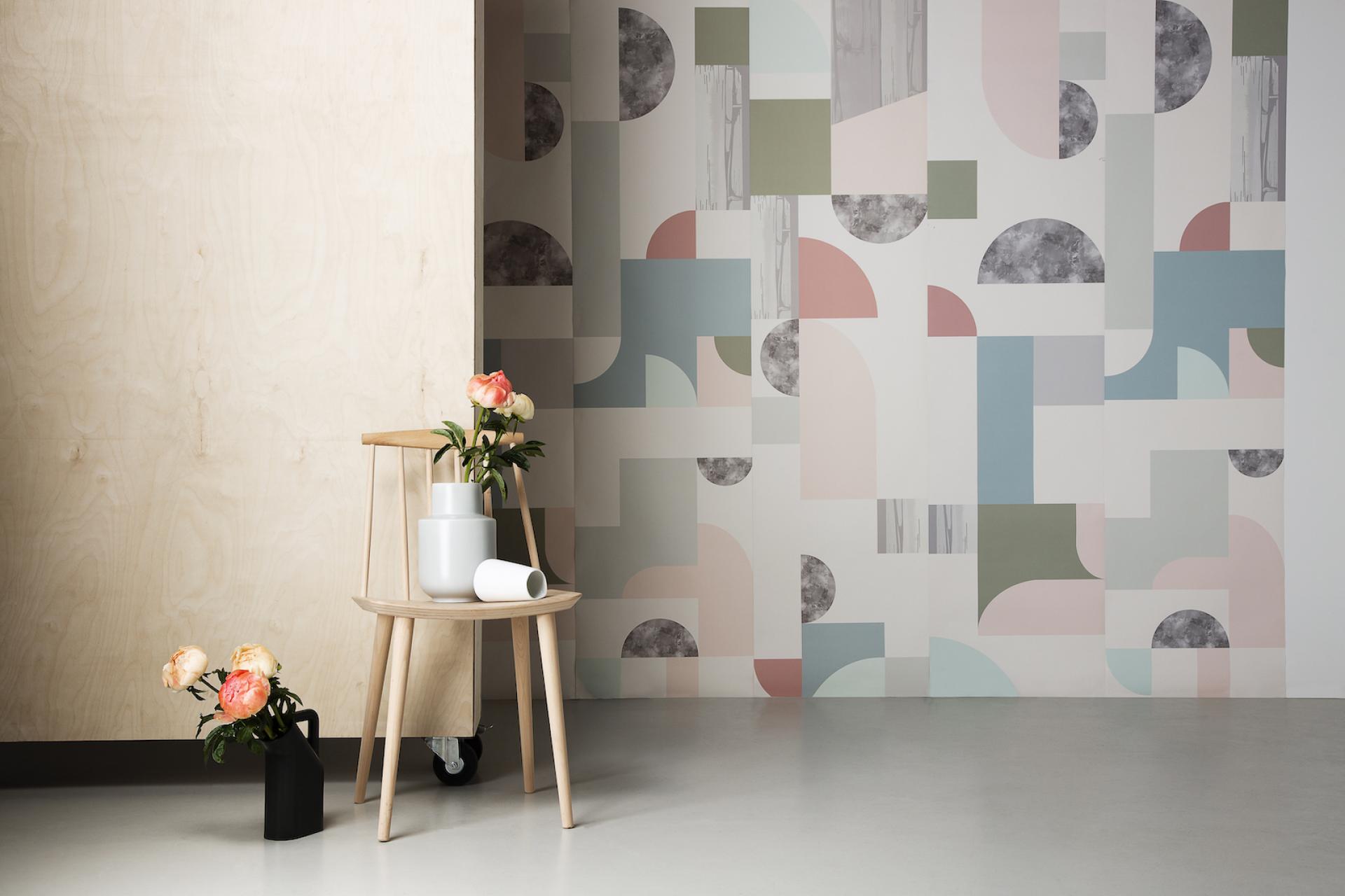 Bespoke Atelier's unique wallpaper design featuring abstract shapes in pastel colors, complemented by stylish indoor plants.