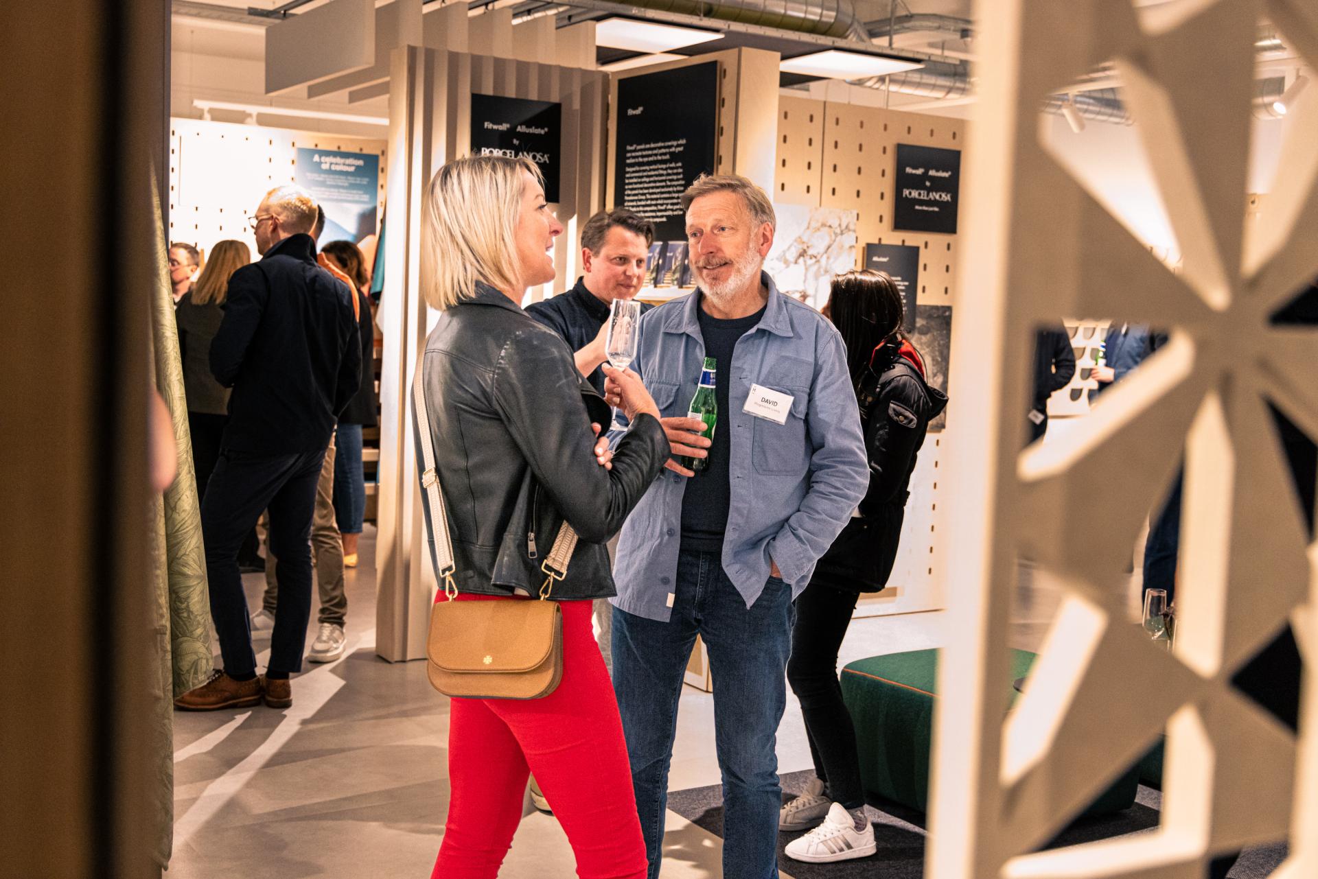 Attendees engage in conversation at the Manchester Property Outlook seminar, showcasing networking in the property development industry.
