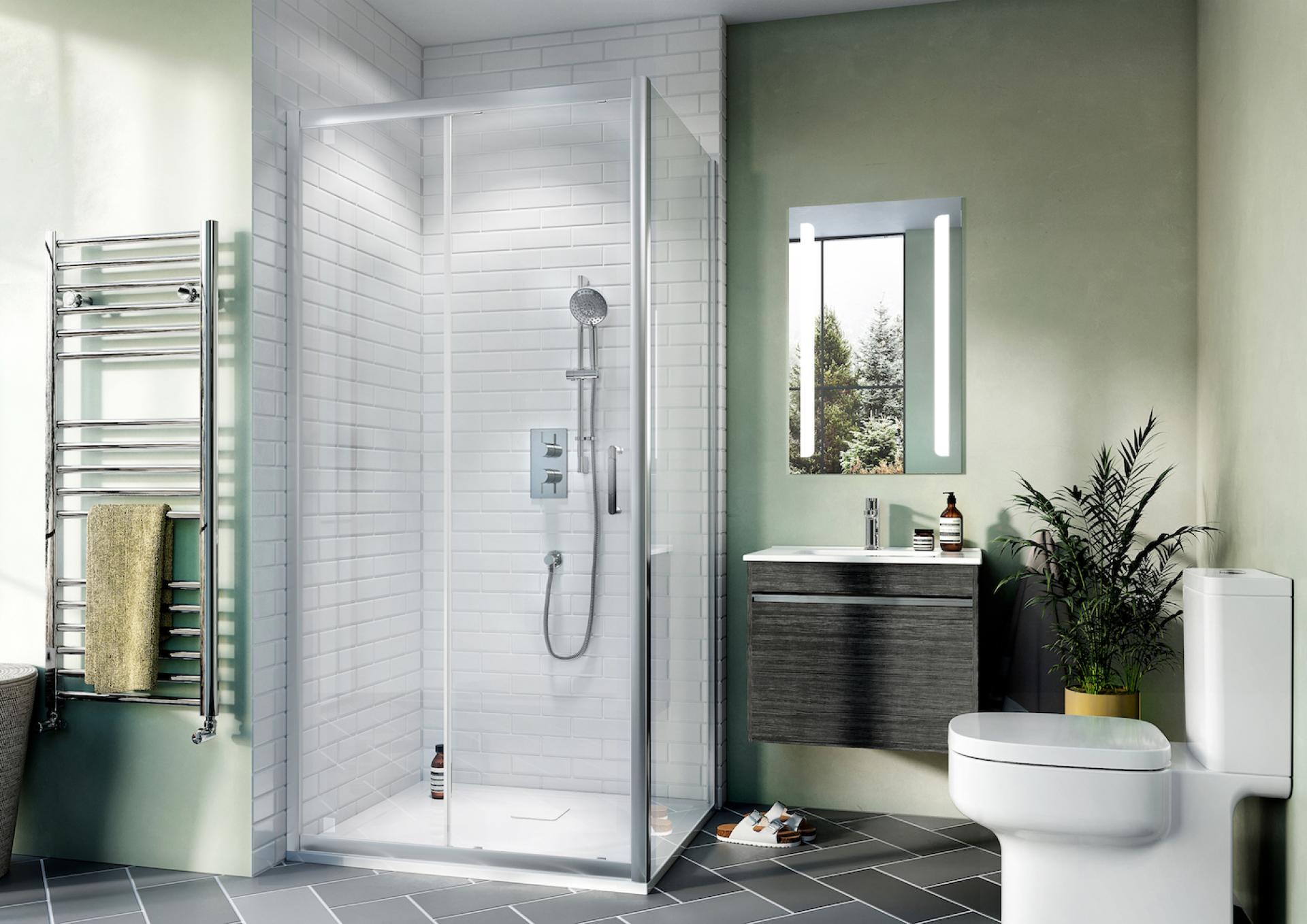 Modern bathroom featuring a sleek glass shower, minimalist storage, and greenery, showcasing 2022 design trends.