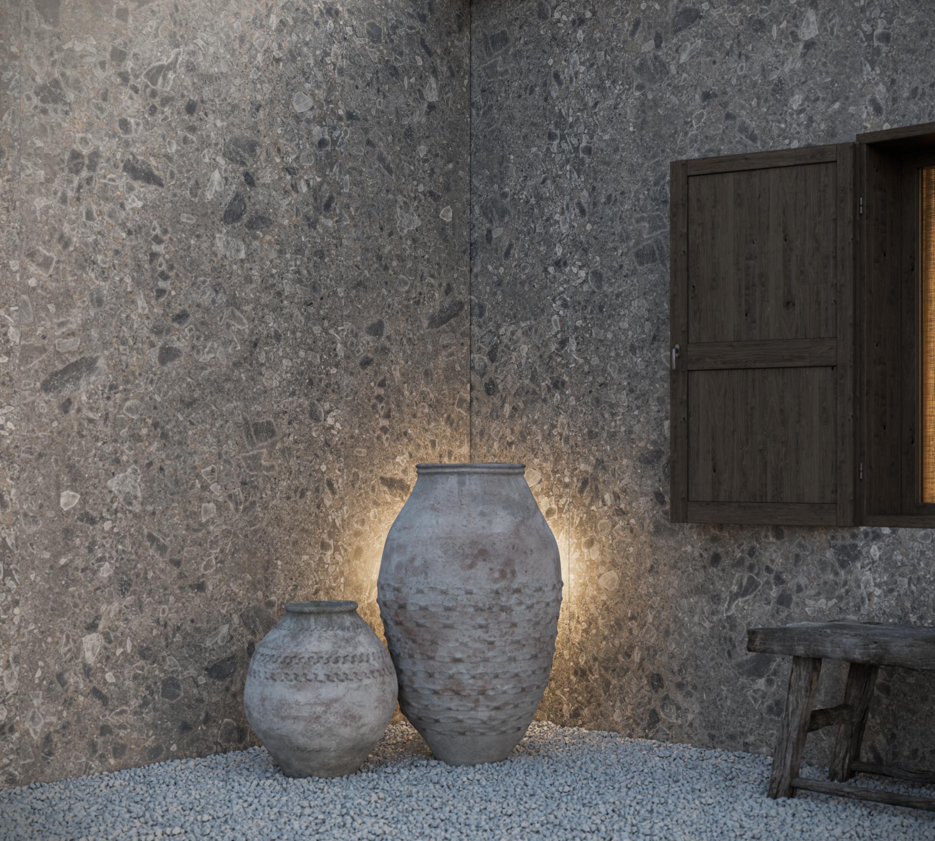 Pietra Kode collection showcasing elegant ceramic vases against a textured stone wall, inspired by Italian architecture.