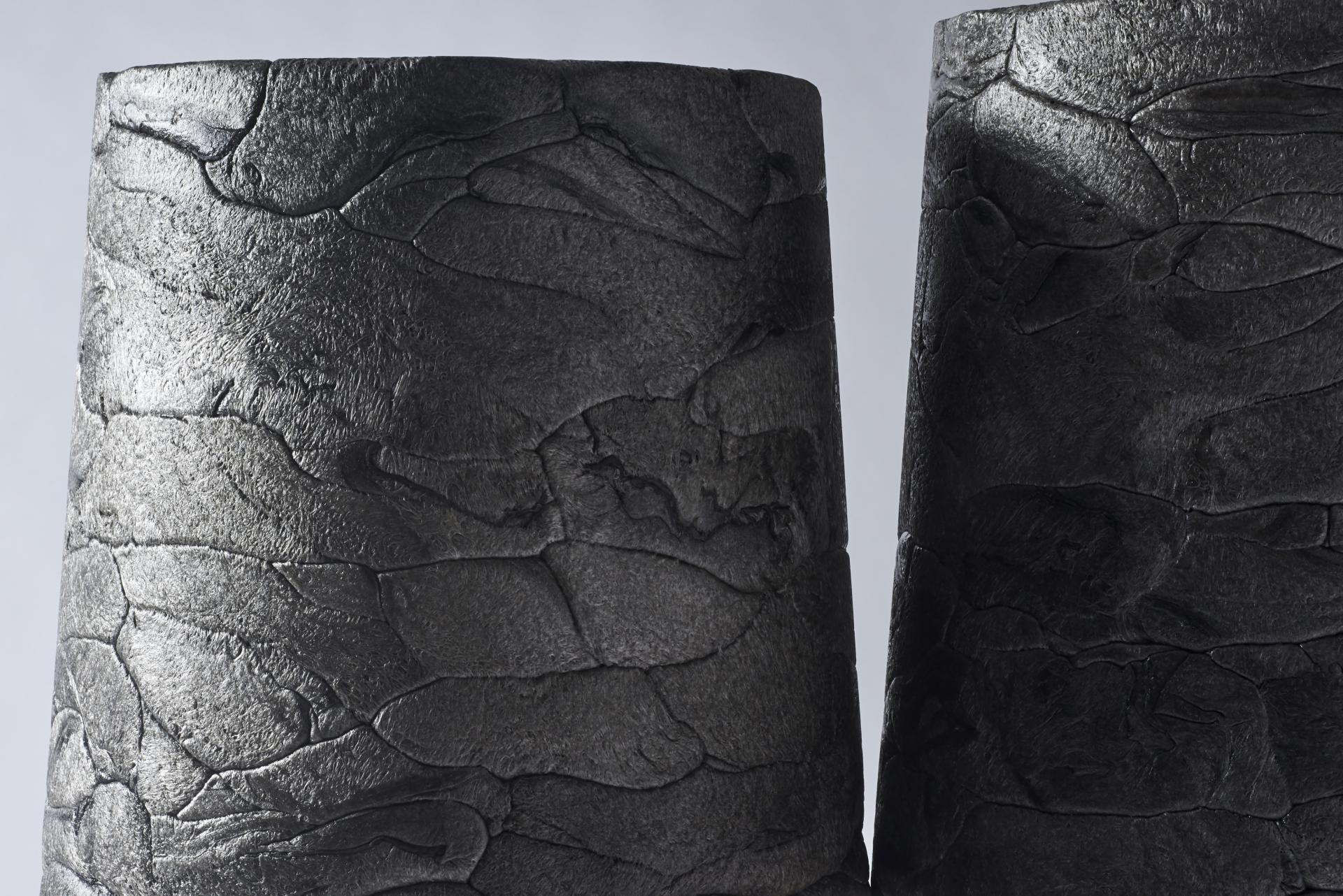 Textured black vases, created from recycled styrofoam, showcasing innovative design and sustainable practices by we+ studio.