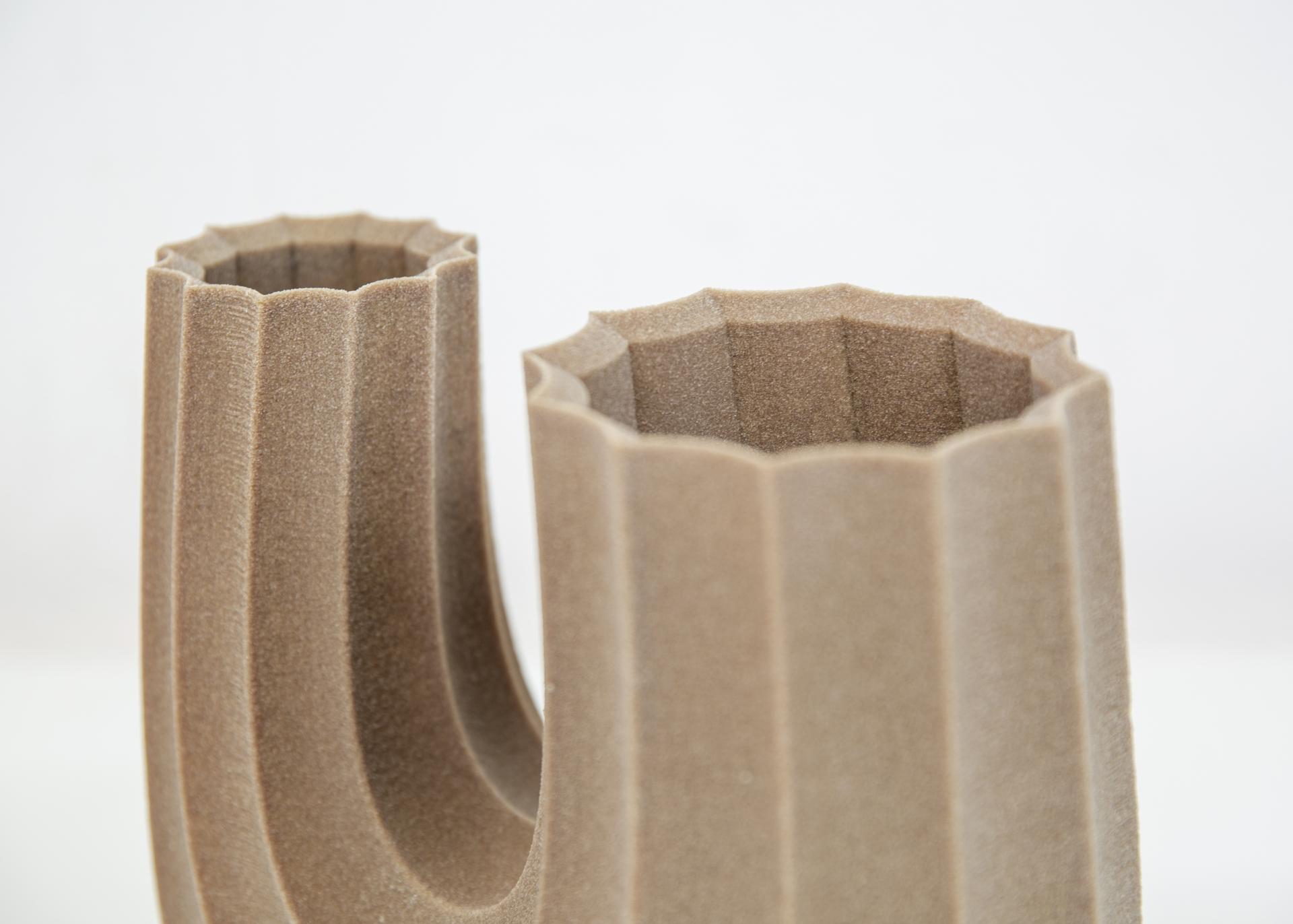 3D-printed architectural vase showcasing innovative design, highlighting the evolution of materials in construction projects.