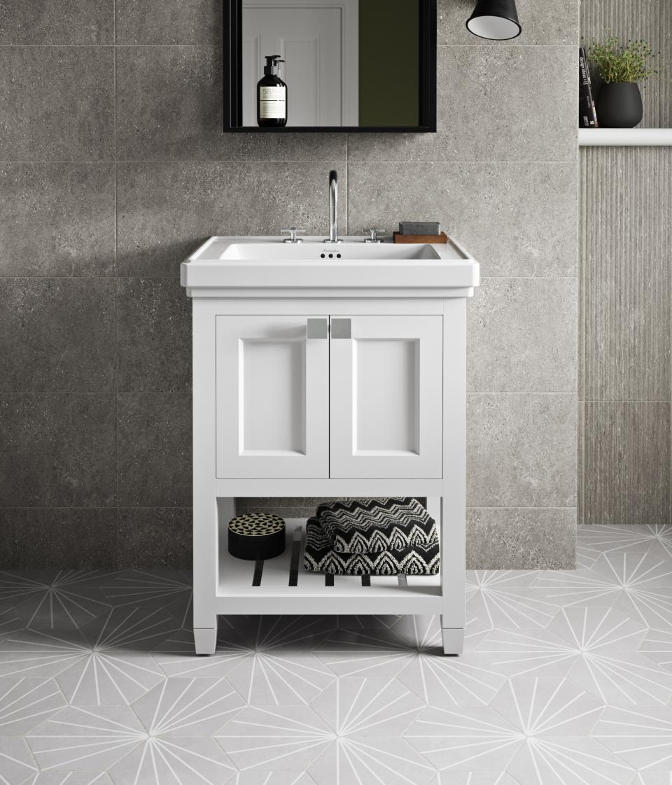 Stylish white bathroom cabinet with sink, paired with elegant patterned flooring and modern minimalist decor elements.