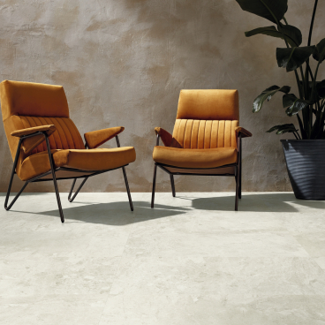 Stylish orange chairs on a light stone floor, showcasing the elegance of Karndean's Van Gogh collection updates.