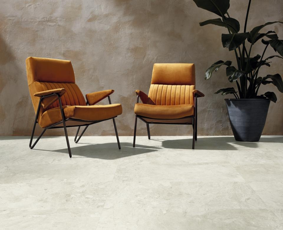 Stylish orange chairs on a light stone floor, showcasing the elegance of Karndean's Van Gogh collection updates.