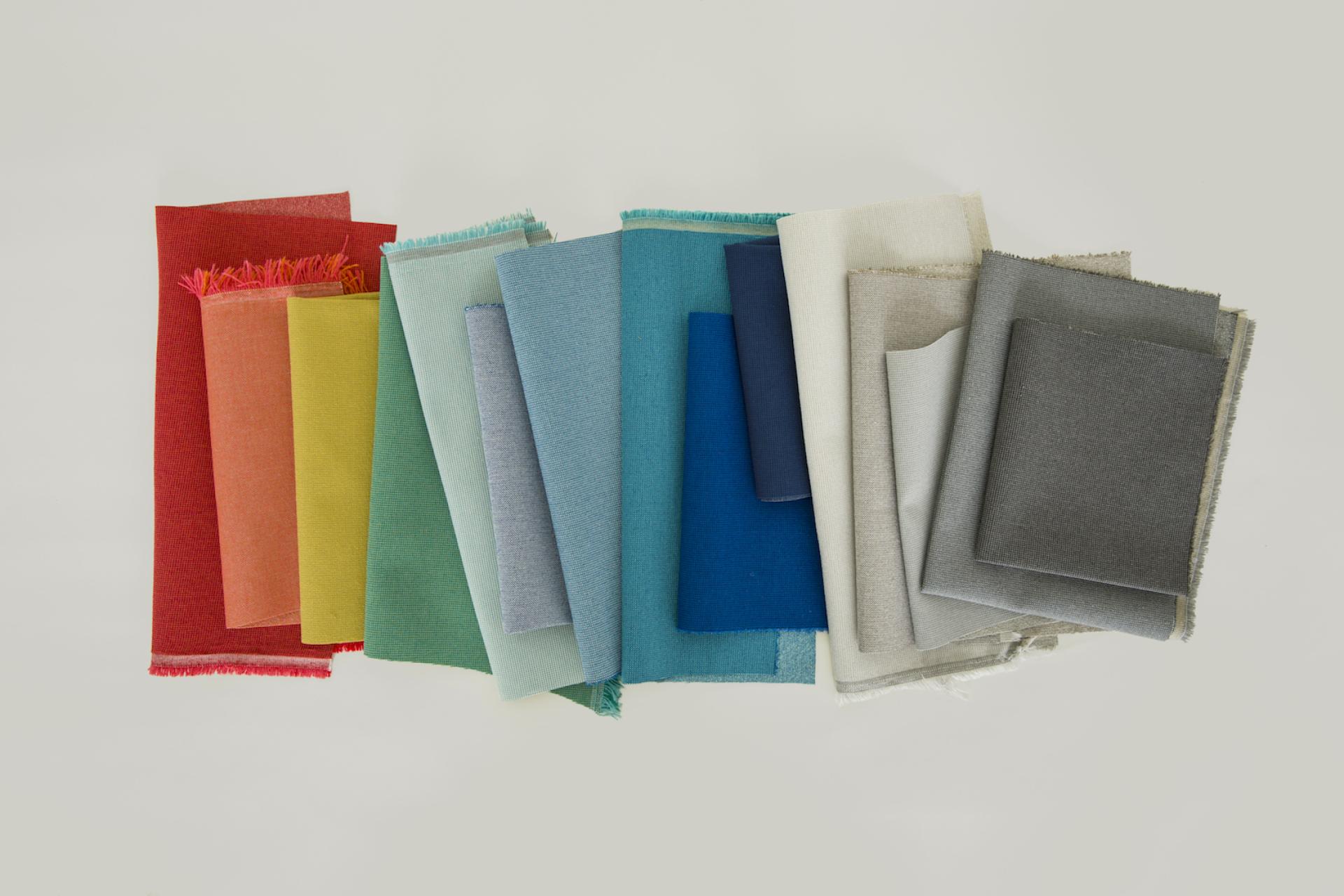 Vibrant fabric swatches from the UP Collection by Kelly Harris Smith, showcasing sustainable and high-performance textile designs.