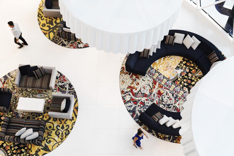 Luxurious interior design of the Mondrian Doha hotel, featuring elegant seating and intricate patterned carpets.