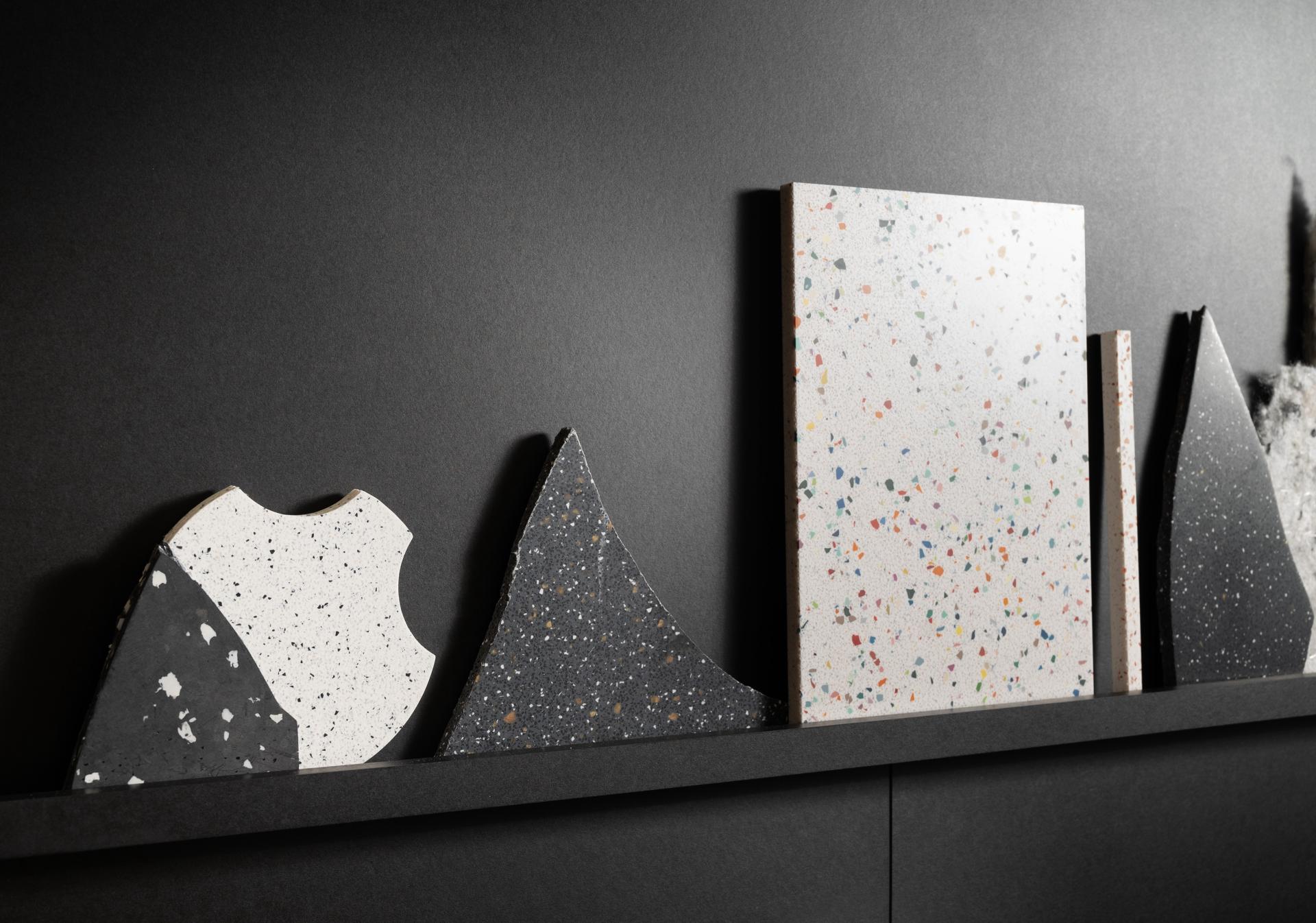 Colorful textured material samples displayed on a black shelf, showcasing Surface Matter's innovative circular Material Rescue initiative.